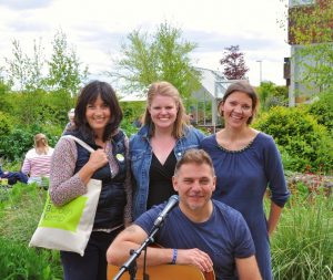 Olivia Chapple, the founder of Horatio’s Garden, with Bolt Burdon Kemp lawyers (Alex Dabek and Victoria Oliver,) and the local musician, Jim at Horatio’s Garden, Salisbury