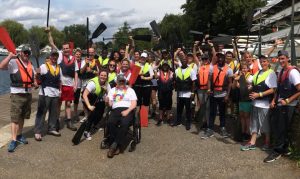 Ready for the dragon boat race, oars in hand and swimming vests in place