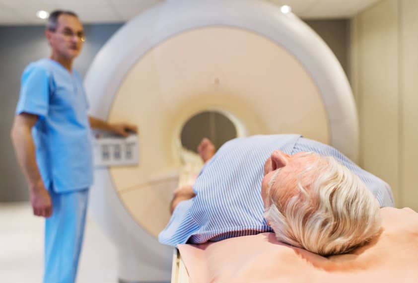 Senior receiving an MRI Scan.