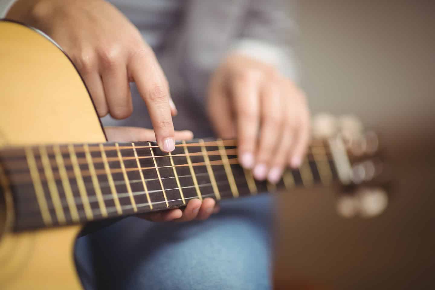 Teacher,Giving,Guitar,Lessons,To,Pupil,In,A,Classroom