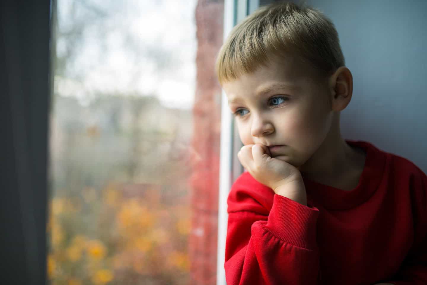 Small,Boy,Sitting,Near,Window,And,Thinking,About,Something